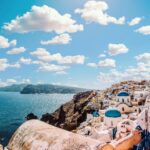 Captivating view of Santorini's famous blue-domed buildings under a vibrant sky.